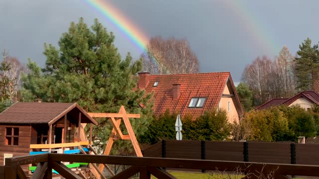 Beautiful rainbow in the sky cottage house