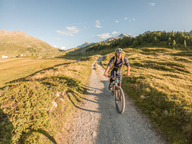 istock Mountain biker descends trail in the Alps 1477120072
