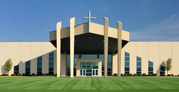 Modern church with symmetrical design under clear blue sky