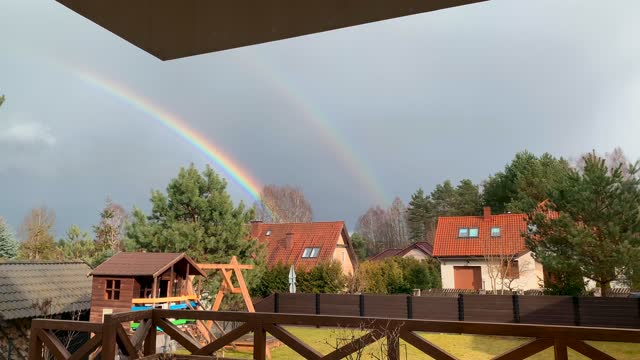 Beautiful rainbow in the sky cottage house