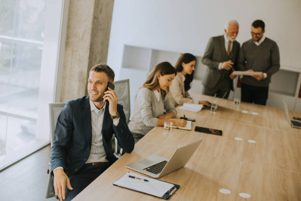 istock Young business man using mobile phone in the office 1477127594