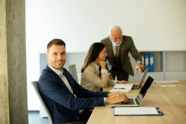 istock Young business man using laptop computer in the office 1477127597