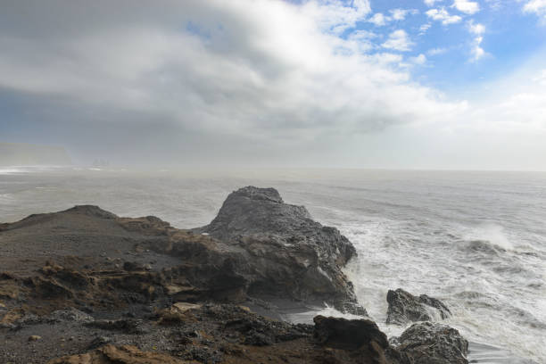 istock Storm clouds over Dyrholaey black basalt sand beach 1477130992