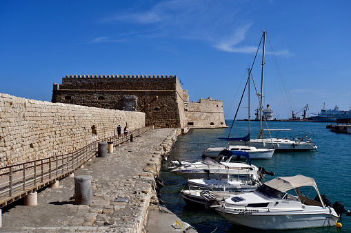 Iraklio, Greece - October 14, 2022: The capital of Crete Island, the small harbor for yachts and fishing boats with the venetian fortress Koules