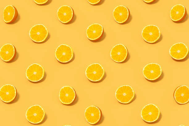 istock Orange Slices with Sunlight on Yellow Background 1477134571