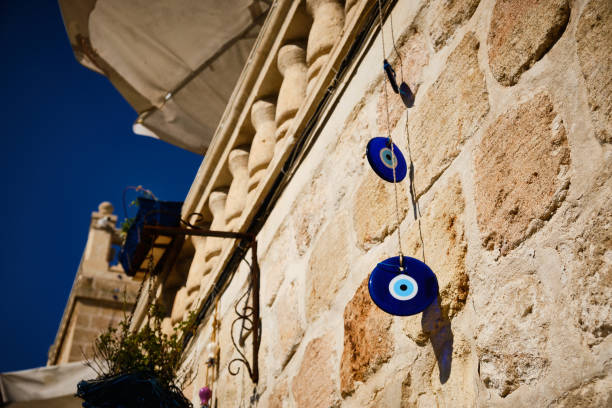 Hanging evil-eye amulets Hanging evil-eye amulets. Nazar is an eye-shaped amulet believed to protect against the evil eye midyat photos stock pictures, royalty-free photos & images