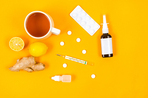 Medicines for treatment- pills, spray bottles, thermometer, Lemon, ginger and tea. traditional and folk methods of treatment. Pharmaceuticals and medicine. Illness concept.