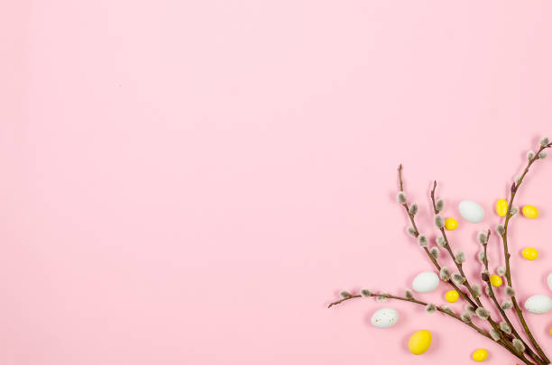 istock Easter Colorful candy chocolate eggs and brunch willow on pastel pink background. 1477136684
