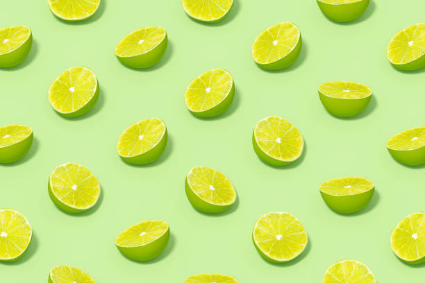 istock Green Lime Slices with Sunlight on Green Background 1477139781