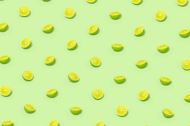 istock Green Lime Slices with Sunlight on Green Background 1477139877