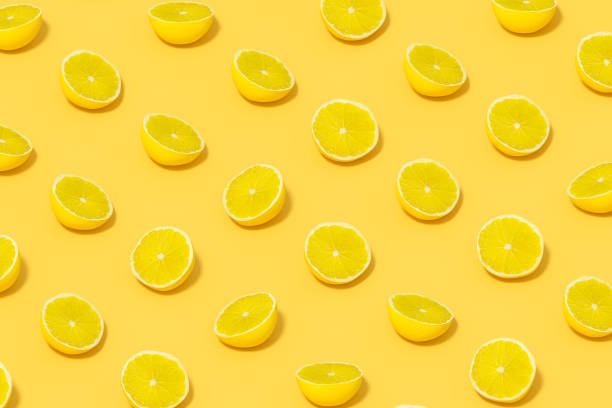 istock Yellow Lime Slices with Sunlight on Yellow Background 1477142631