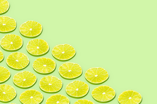 Green Lime Slices with Sunlight on Green Background, 3d render.