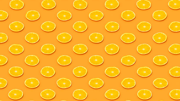 istock Orange Slices with Sunlight on Orange Color Background 1477143691