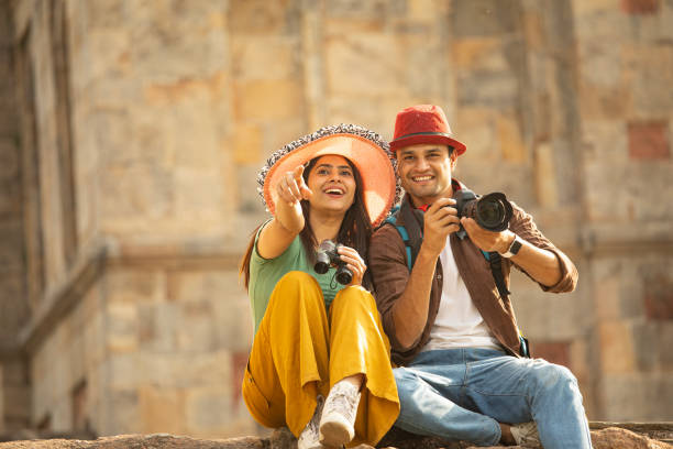 istock Couple admiring view using binoculars and camera at historic site 1477144965