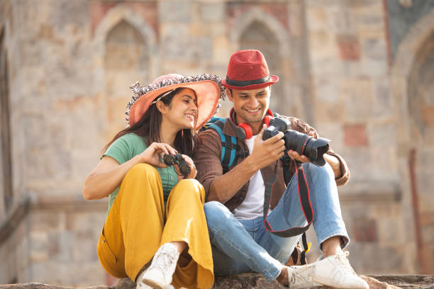 istock Couple admiring view using binoculars and camera at historic site 1477145559