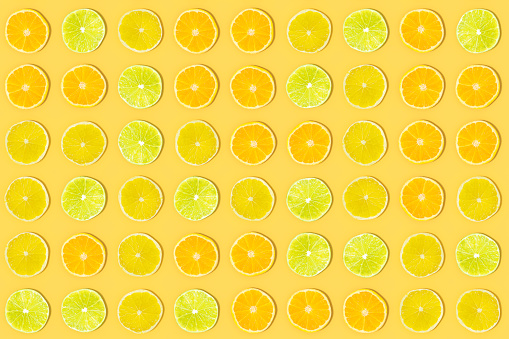 Lime and Orange Fruit Slices with Sunlight on Yellow Color Background, 3d render.