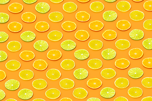 Lime and Orange Fruit Slices with Sunlight on Orange Color Background, 3d render.