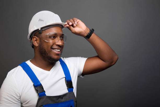 istock Smiling black man in modern overalls loves to work 1477150699
