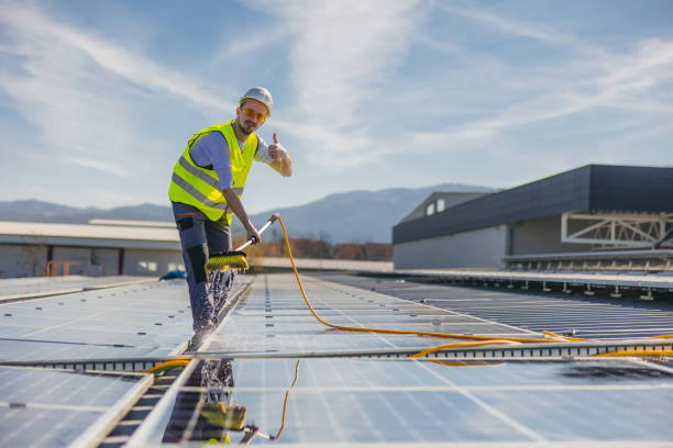 istock Young man cleaning solar panels 1477151971