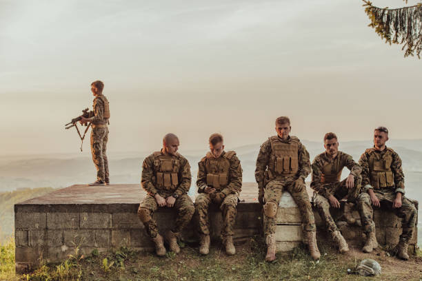 istock Soldiers squad relaxing after battle having a break on training 1477152139