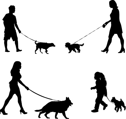 woman and kid walking with his dog silhouettes