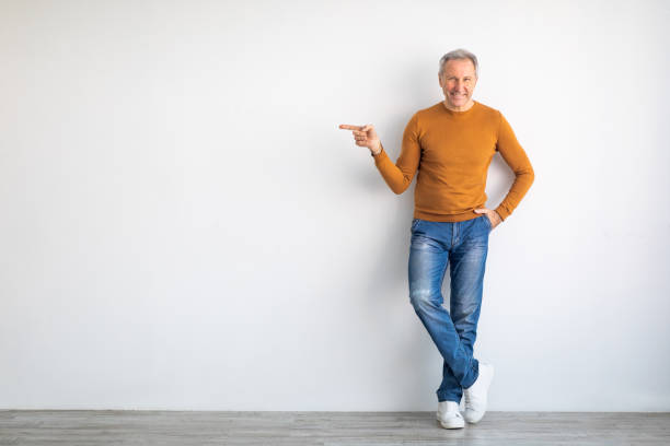 istock Excited senior man pointing aside at free copy space 1477153665