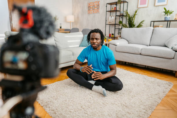 istock Young Man Filming A Vlog On Exercising At Home 1477154479