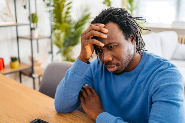 istock Sad Young Man Sitting At Home At The Kitchen Table 1477154520