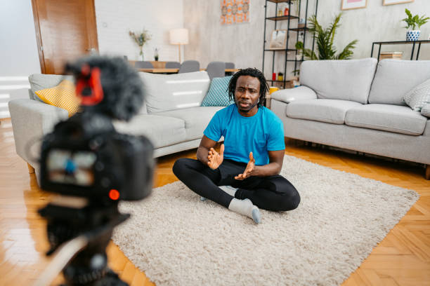 istock Young Man Filming A Vlog On Exercising At Home 1477156535