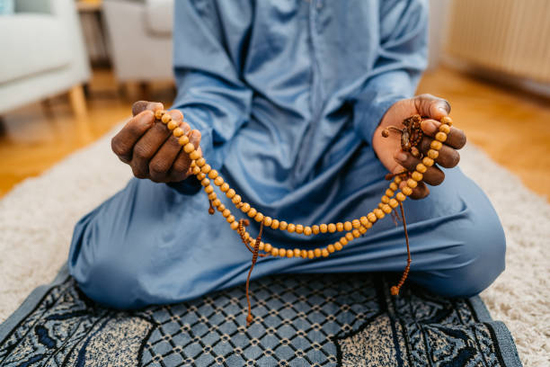 istock Young Black Muslim Man Praying At Home Using Misbaha 1477156639