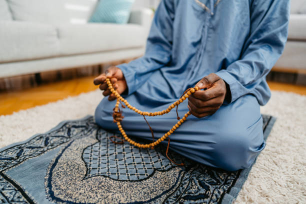 istock Young Black Muslim Man Praying At Home Using Misbaha 1477163438