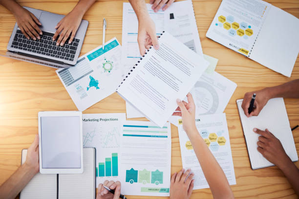 istock Hands, startup meeting or business people in data review for project management, SEO documents consult or collaboration. Digital agency, paper or agenda for planning, creative innovation or teamwork 1477164504