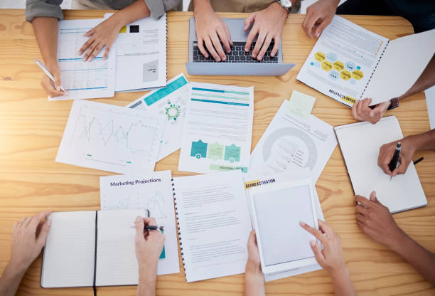 istock Meeting, documents or business people hands in project management data review, SEO startup consult or collaboration. Digital agency, top view or planning for research, creative innovation or teamwork 1477164513