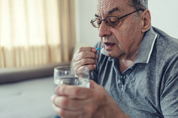 istock Elderly man taking pills for depression. 1477164720