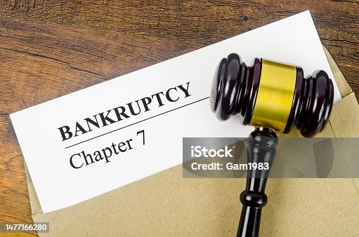 istock The Bankcrupty Chapter 7 text on Document form and Wooden Gavel on office desk. 1477166280