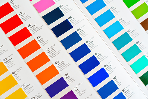 Vibrant colors swatches - adhesive film - with colour names in English, German, French, Polish and Russian, closeup detail