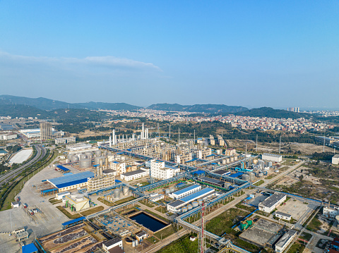 Aerial view of a chemical plant in operation under a blue sky