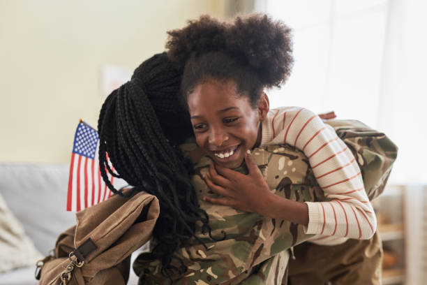 istock Girl embracing her mom returning from war 1477180950