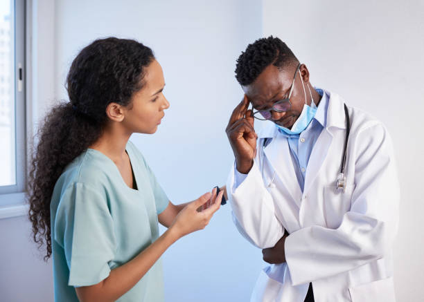 istock Nurse in scrubs comforts doctor after unsuccessful surgery, burnout, upset 1477181451