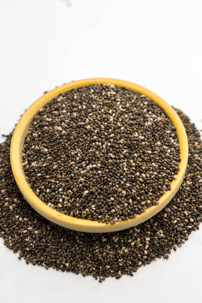 Chia seeds in yellow bowl stock photo