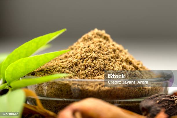 Garam Masala In Bowl With Green Curry Leaves Stock Photo - Download Image Now - Agriculture, Bowl, Cinnamon