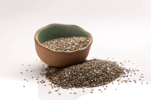 Chia seeds in green and brown bowl stock photo