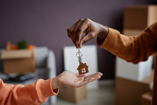 istock Real estate agent giving keys to owner 1477182544