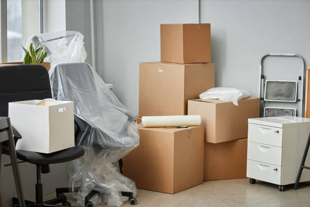 istock Relocation to a new office with boxes and furniture 1477182580