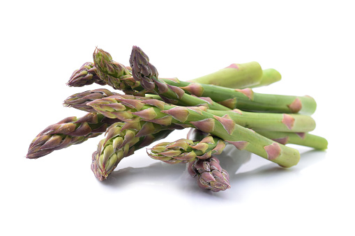 Raw fresh uncooked green asparagus sprouts isolated on white