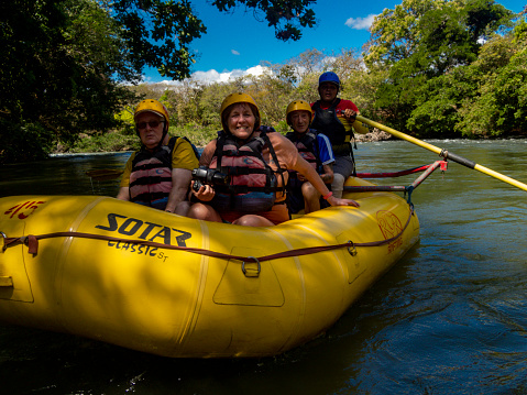 A group of tourists on a raft trip down the Rio Corobici in Costa Rica.