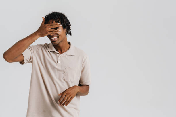 istock Black young man with braids smiling and covering his eyes 1477185383