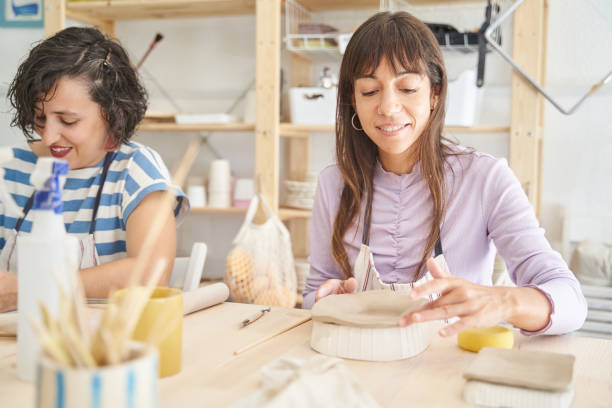 istock Women making handmade pottery in a pottery class. 1477185955