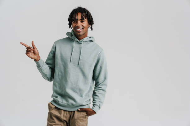 istock Black young man with braids smiling and pointing finger aside 1477186865