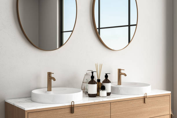 istock 3D render close up white vanity counter with ceramic washbasin and modern style faucet in a bathroom with morning sunlight and shadow. Blank space for products display mockup. Background. 1477191503